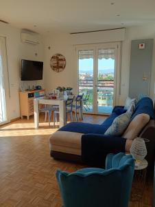 a living room with a large couch and a table at A Casa Di Dona in Rimini