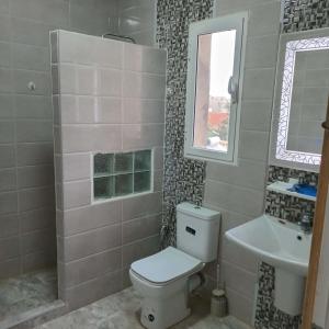a bathroom with a toilet and a sink at Littlhouse in Rafrāf +9 photos