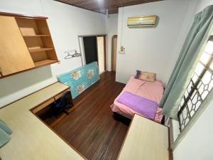 a small room with a bed and a desk at Lingkudau Homestay in Keningau