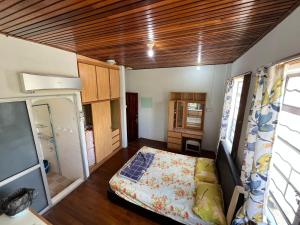 a small room with a bed in a room at Lingkudau Homestay in Keningau