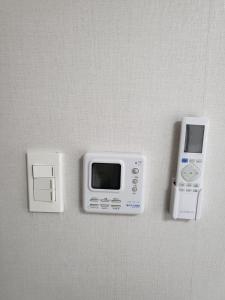 a microwave and an ipod on a wall at 씨하우스 501호 in Hakch'ŏn-dong