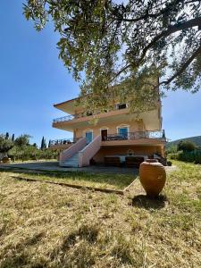 a large house with a vase in front of it at Elia in Marathon