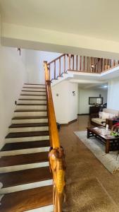 a staircase in a living room with a stair case at Ceylon Mist Villa in Narandanda
