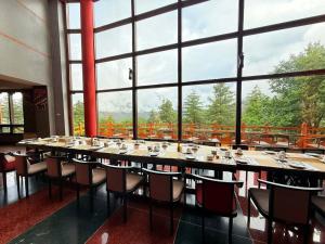 a large dining room with a long table and chairs at Haven Resort Paro in Paro +25 photos