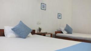 Postel nebo postele na pokoji v ubytování D'Villa Guest House