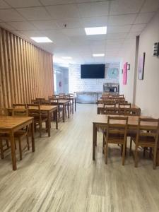 an empty classroom with wooden tables and chairs at COLIBRI in Calella
