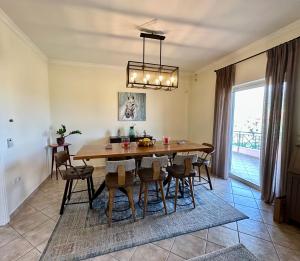 a dining room with a wooden table and chairs at Elia in Marathon