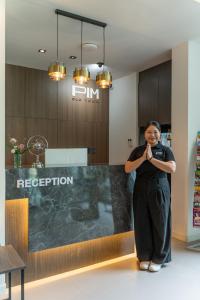 a woman is standing in front of a counter at Pim Old Town in Chiang Mai +138 photos