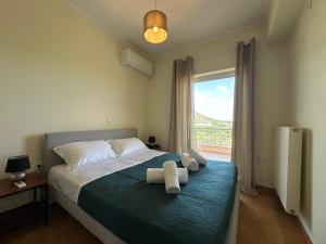a bedroom with a bed with two towels on it at Elia in Marathon