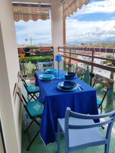 a dining room with blue tables and chairs on a balcony at A Casa Di Dona in Rimini