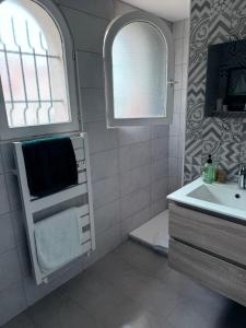 a bathroom with a sink and a toilet and a mirror at Logis des pêcheurs in Meschers-sur-Gironde