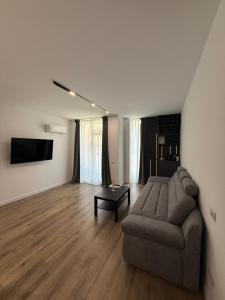 a living room with a couch and a table at Sterling House in Timişoara