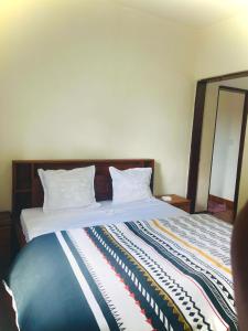 a bedroom with a large bed with white pillows at Chez Pauline in Sainte Marie +8 photos