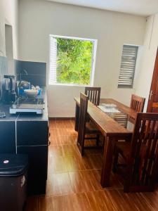 a kitchen with a table and a dining room at Chez Pauline in Sainte Marie