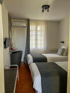 a hotel room with two beds and a window at Hôtel Castel Saint Anne in Le Castellet +53 photos