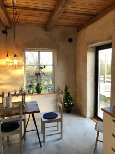 a kitchen with a table and chairs and a window at Drängagården in Klagstorp