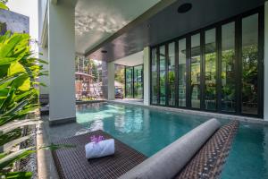 an infinity pool in a building with a house at Pim Old Town in Chiang Mai