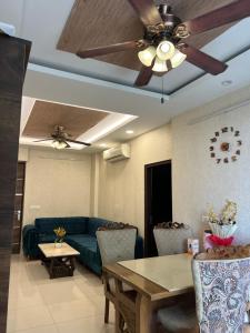 a living room with a couch and a ceiling fan at Casa Luxoria in Jalandhar