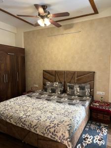 a bedroom with a bed with a ceiling fan at Casa Luxoria in Jalandhar