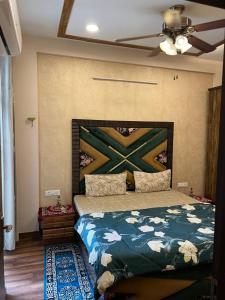 a bedroom with a bed with a painting on the wall at Casa Luxoria in Jalandhar