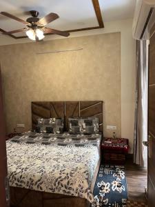 a bedroom with a bed and a ceiling fan at Casa Luxoria in Jalandhar