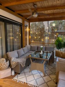 a living room with a couch and a table at Mobile Home Sea Heaven in Biograd na Moru