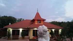 a building with a statue in front of it at Bornemisza Kuria in Tiszabecs