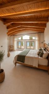 a bedroom with a large bed with a wooden ceiling at Villa Magganas in Nikiana +149 photos