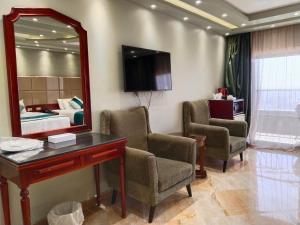 a room with a desk and a bed and a mirror at Nile Royale Hotel in Cairo +22 photos