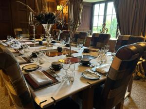 a long table in a room with chairs around it at Rorrington Hall in Chirbury