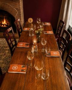 a group of wooden tables with wine glasses on them at Hôtel La Madeleine in Saint-Benoît-sur-Loire +8 photos