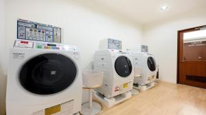 a row of white washing machines in a room at Quintessa Hotel Akita in Akita +26 photos