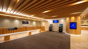a waiting room with two tvs on the wall at Quintessa Hotel Akita in Akita