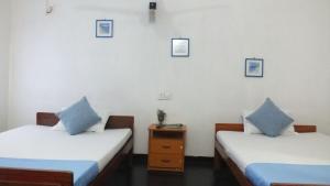 Postel nebo postele na pokoji v ubytování D'Villa Guest House