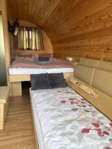 a bedroom with two beds in a wooden cabin at Schaumburger Fass in Rinteln