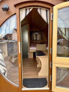 an open door of a tiny house with a bedroom at Schaumburger Fass in Rinteln +6 photos