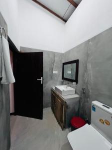 a bathroom with a sink and a mirror at Jesoloresort Arugambay in Arugam Bay +20 photos