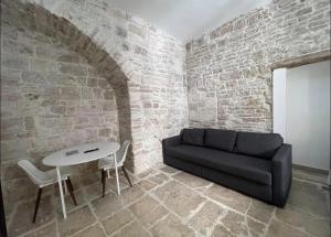 a living room with a couch and a table at Casa-Torre Normanna in Bitonto