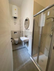 a bathroom with a shower and a sink and a toilet at Casa-Torre Normanna in Bitonto +24 photos