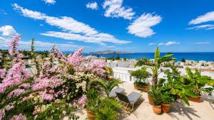 a view from the roof of a resort with pink flowers at Kurmulis Studios in Stalos