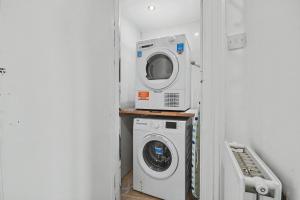 a laundry room with a washer and a washing machine at 173 Newark Street, Greenock in Greenock +8 photos