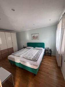 a bedroom with a large bed in a room at Ferienhof Buschle in Bermatingen