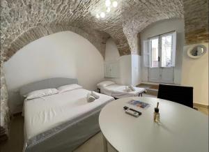 a bedroom with a bed and a table in it at Casa-Torre Normanna in Bitonto