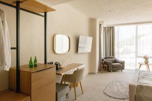 a bedroom with a bed and a desk in a room at Blu Mare Residense in Odesa