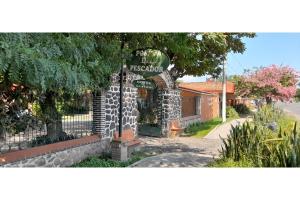 a building with a sign on top of it at Capital O Posada Del Pescador Jocotepec in Chapala