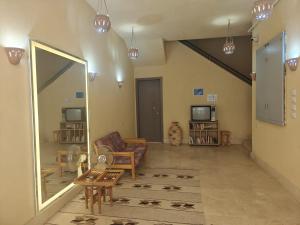 a living room with a mirror and a couch at Bayt Hassan A13 - Superb 2 bedrooms in Hurghada
