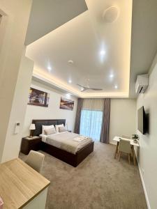 a bedroom with a bed and a desk and a tv at Harbour Retreat in Hayborough