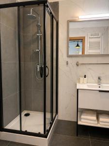 a bathroom with a shower and a sink at Apartamenty Przy Forcie in Kłodzko +26 photos