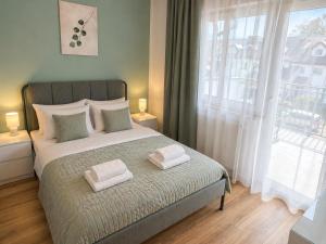 a bedroom with a bed with two towels on it at Apartamenty Przy Forcie in Kłodzko