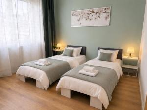 a room with two beds with towels on them at Apartamenty Przy Forcie in Kłodzko